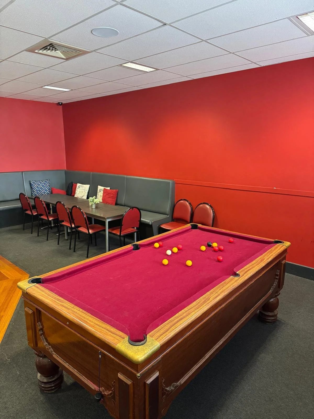 Red-felt pool table in the hotel games room